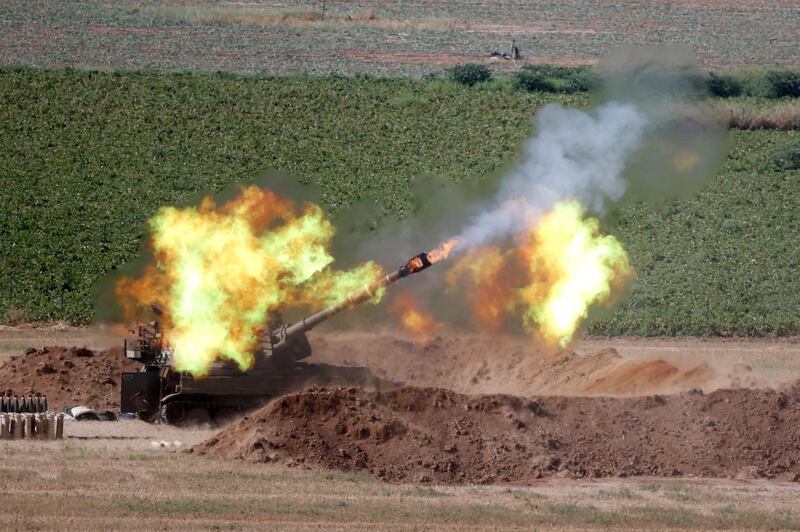 Israeli soldiers fire a 155mm Howitzer towards the Gaza Strip from their position along the border with the Palestinian enclave. AFP