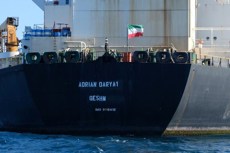 (FILES) In this file photo taken on August 18, 2019 an Iranian flag flutters on board the Adrian Darya oil tanker, formerly known as Grace 1, off the coast of Gibraltar. An Iranian tanker released after being detained for six weeks by the British overseas territory of Gibraltar is now headed for Lebanon, Turkey's Foreign Minister Mevlut Cavusoglu said on August 30, 2019. / AFP / Johnny BUGEJA
