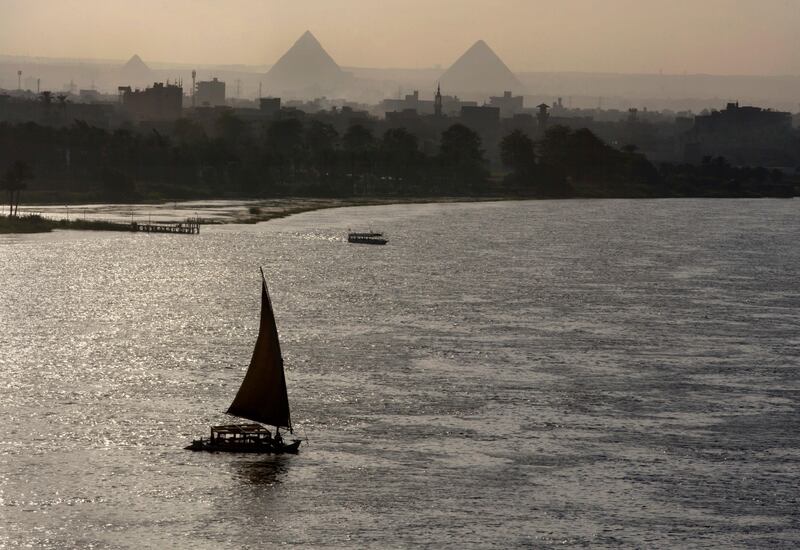 Holiday makers take a boat tour on the Nile River past the Great Pyramids, in Cairo, Egypt, Friday, Aug. 18, 2017. (AP Photo/Amr Nabil)