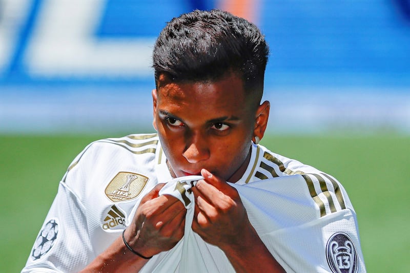 Rodrygo kisses the Real Madrid badge on his jersey during his unveiling. EPA