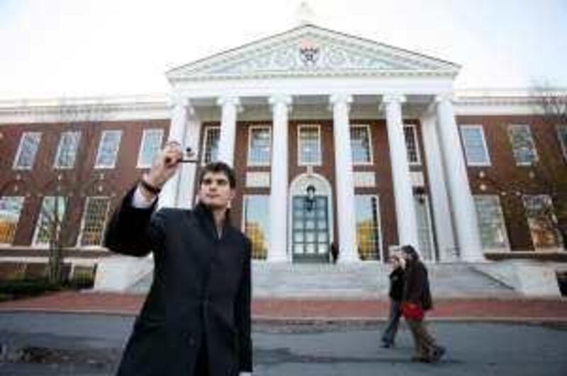 An unidentified man takes a photograph at the Harvard Business School in Boston, Massachusetts on Monday, November 7, 2005. The compensation of recent business school graduates from Harvard, Dartmouth and Stanford rose at least 9.5 percent from a year earlier, fueled by increased hiring at investment banks and consulting firms. Photographer: Michael Fein/Bloomberg News