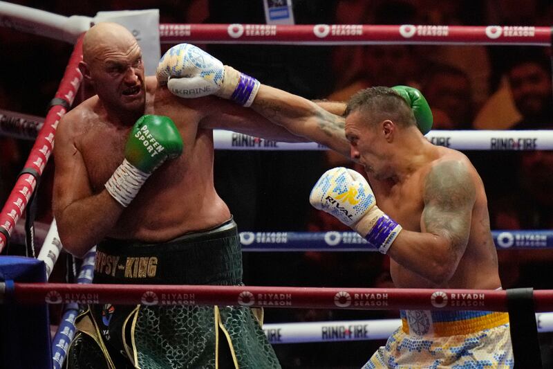 Tyson Fury and Oleksandr Usyk trade blows during their undisputed heavyweight world championship boxing fight. AP