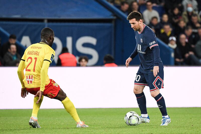 Lionel Messi on the ball up against Lens defender Massadio Haidara. AFP