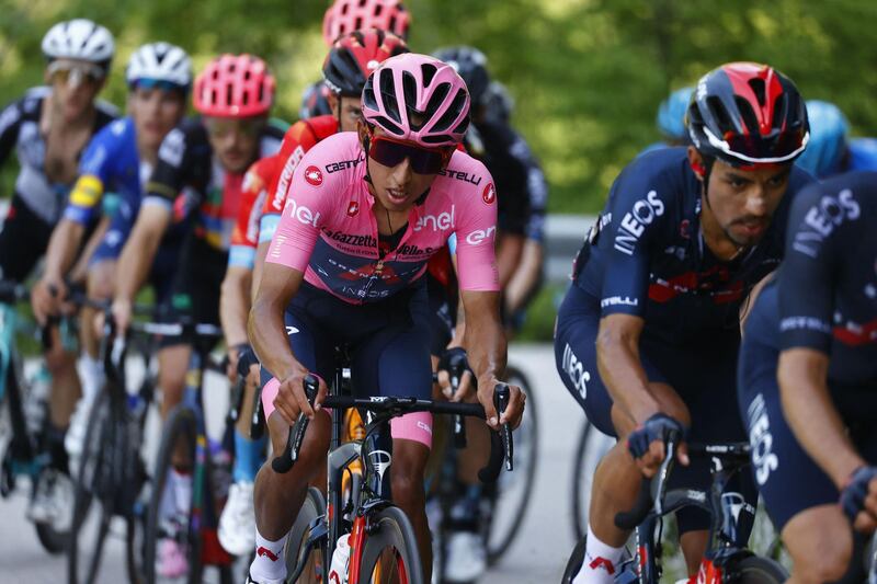 Overall leader Team Ineos rider Colombia's Egan Bernal (C) rides in the pack through the Passo di San Valentino pass during the 17th stage of the Giro d'Italia 2021 cycling race, 193km between Canazei and Sega di Ala on May 26, 2021.   / AFP / Luca Bettini

