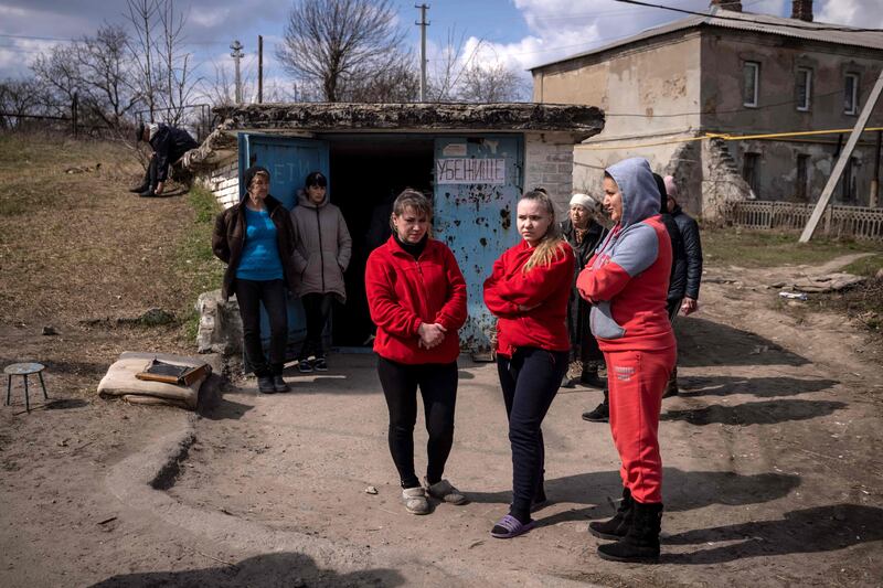 Residents gather outside a shelter in the city of Severodonetsk. AFP