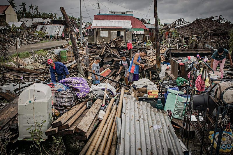 Residents try to salvage belongings in San Policarpio town, Eastern Samar province. AFP