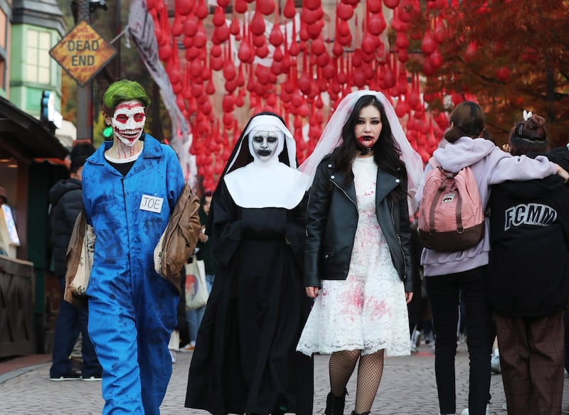 Visitors to Everland amusement park in Yongin, Seoul, South Korea, show off their Halloween costumes. EPA
