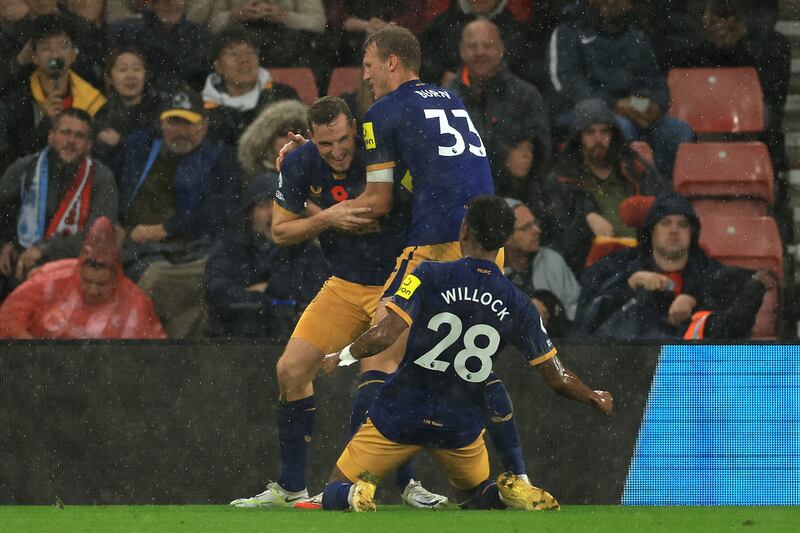 Newcastle's Chris Wood celebrates with teammates after scoring. Getty