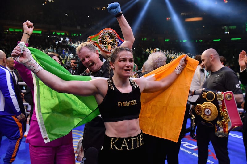 Irish boxer Katie Taylor (C) celebrates after defeating Puerto Rican boxer Amanda Serrano for the World Lightweight Title fight at Madison Square Garden on April 30, 2022 in New York City.  (Photo by Angela Weiss  /  AFP)