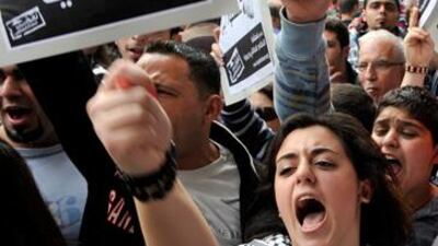 Lebanese protesters hold a placard reading in Arabic 'a secular democracy' during a demonstration calling for the end of the 'confessional' political system in Beirut.