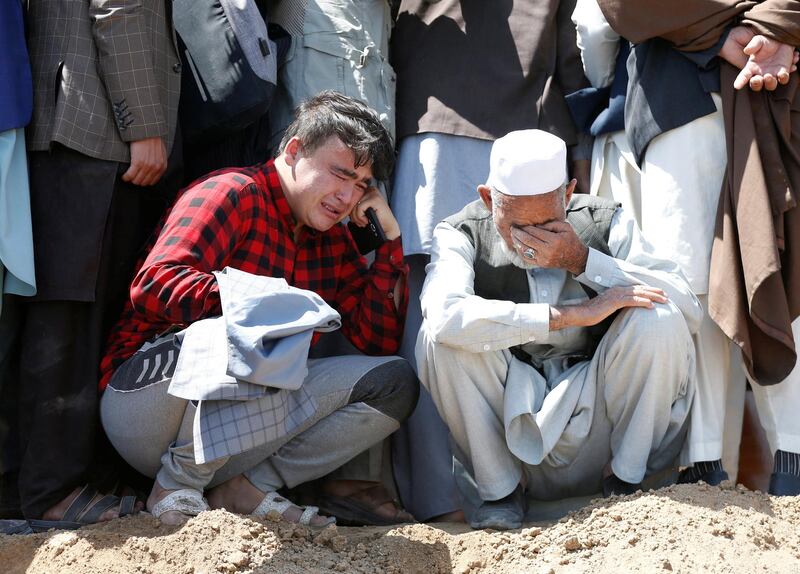 Relatives mourn the victims of an explosion during a mass funeral ceremony in Kabul, on July 7, 2021. Reuters