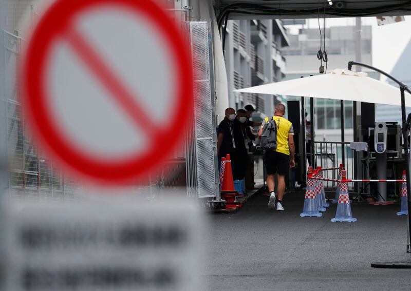 A team official of Belgium walks towards a security checkpoint at the entrance to the Olympic Village.