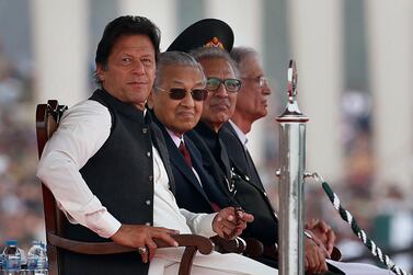 From left, Pakistani Prime Minister Imran Khan, his Malaysian counterpart Mahathir Mohamad and Pakistani President Arif Alvi attend Pakistan's Republic Day parade in Islamabad on March 23, 2019. AP Photo