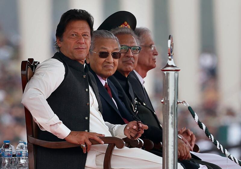 Malaysian Prime Minister Mahtir Mohamad, second left, with his Pakistani counterpart Imran Khan, and Pakistani President Arif Alvi attend Pakistan National Day parade in Islamabad, Pakistan, Saturday, March 23, 2019. Pakistanis are celebrating their National Day with a military parade that's showcasing short- and long-range missiles, tanks, jets, drones and other hardware. (AP Photo/Anjum Naveed)