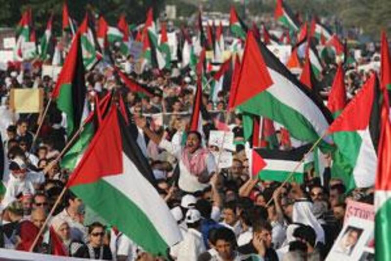 Protesters wave Palestinian flags during demonstrations on the Abu Dhabi Corniche. Marches in other emirates also opposed Israel's continuing campaign into Gaza.