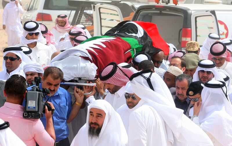 People carry the coffin of Al Jazeera news network cameraman, Ali Hassan al-Jaber, during his funeral in Doha Monday March 14, 2011. The Al-Jazeera cameraman was killed in an ambush near the eastern Libyan city of Benghazi on Saturday, the first journalist slain in the nearly month-long conflict, the satellite station said. (AP Photo/Osama Faisal) *** Local Caption ***  QAT107_Qatar_Libya_Media.jpg