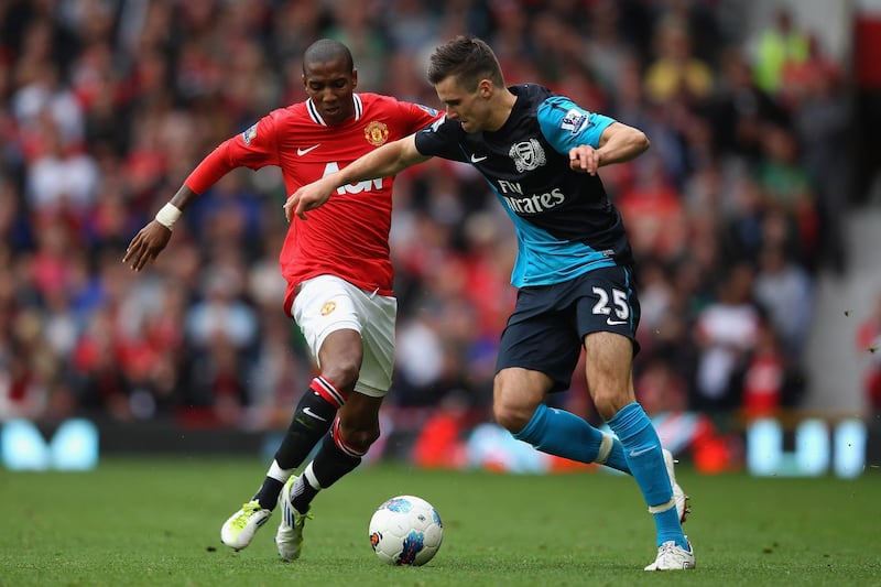 MANCHESTER, ENGLAND - AUGUST 28:  Ashley Young of Manchester United and Carl Jenkinson of Arsenal battle for the ball during the Barclays Premier League match between Manchester United and Arsenal at Old Trafford on August 28, 2011 in Manchester, England.  (Photo by Alex Livesey/Getty Images)