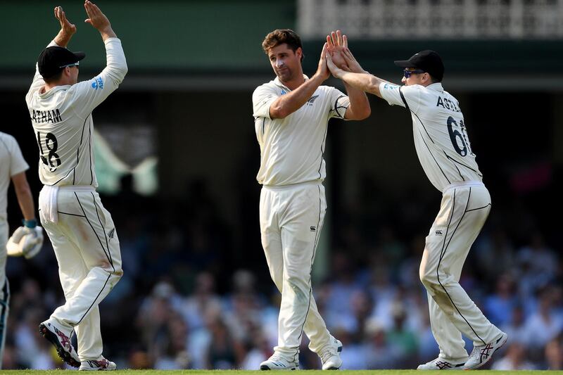 Colin de Grandhomme of New Zealand, centre, celebrates with teammates after taking the wicket of Steve Smith. EPA