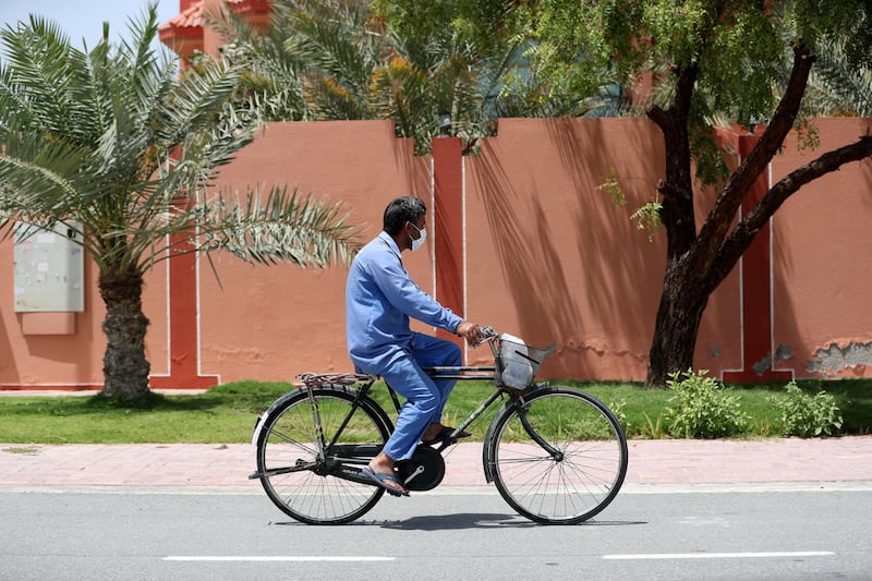 Dubai, United Arab Emirates - Reporter: N/A: A man wears a facemark as he goes about his duties as the country goes into lockdown for 2 weeks due to the corona virus. Wednesday, April 8th, 2020. Dubai. Chris Whiteoak / The National