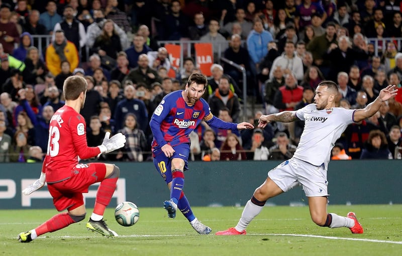 Barcelona's Lionel Messi challenges Levante's goalkeeper Aitor Fernandez. EPA