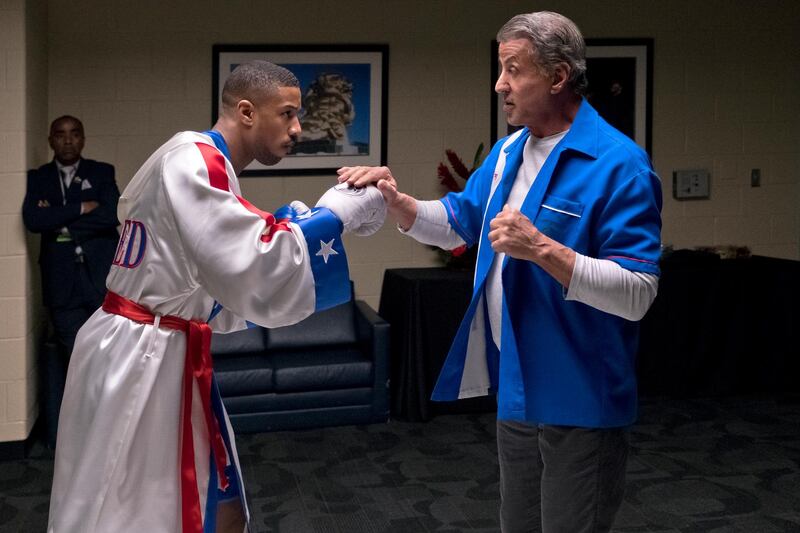 FILE - This image released by Metro Goldwyn Mayer Pictures / Warner Bros. Pictures shows Michael B. Jordan, left, and Sylvester Stallone in a scene from "Creed II." The Rocky spinoff â€œCreed IIâ€ has placed second with $35.3 million from the weekend and $55.8 million since Wednesday, far surpassing the first filmâ€™s Thanksgiving debut in 2015. (Barry Wetcher/Metro Goldwyn Mayer Pictures/Warner Bros. Pictures via AP, File)