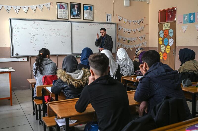 A Syrian teacher gives maths class to Syrian children in a classroom at Sehit Duran primary school in Adana on March 18, 2019.  Like many students of her age, 16-year-old refugee Fatmeh dreams of becoming a doctor. And a modest monthly sum of less than 10 euros could make all the difference.
Originally from the Syrian city of Aleppo, the teenager has been living in Adana in southern Turkey for six years with her father and three small brothers. 
To help feed the family, the father sells Syrian pastries that she helps make at home.
 / AFP / Ozan KOSE
