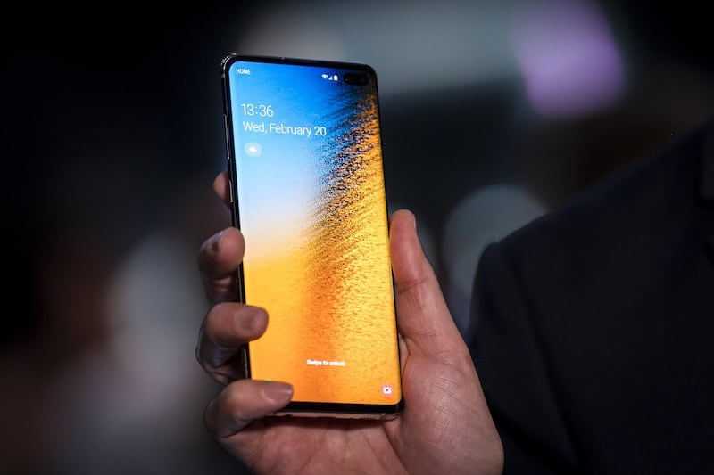 A member of the media holds a Samsung Galaxy 10+ smartphone during the Samsung Electronics Co Unpacked launch event. Bloomberg