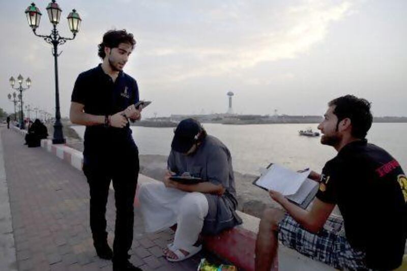 Members of the Abu Dhabi Awards team collect nominations from people along the breakwater in Abu Dhabi on May 4, 2013. Christopher Pike / The National