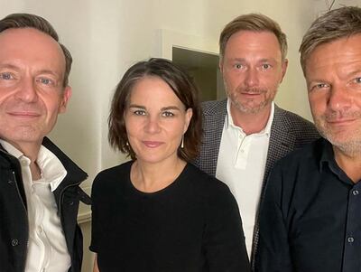 Green co-leaders Annalena Baerbock, second left, and Robert Habeck, right, with FDP leader Christian Lindner, second right, during an initial round of negotiations. AFP