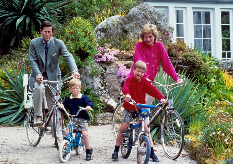 Prince Charles and Princess Diana and their sons, Princes William and Harry, on a cycle ride around the island of Tresco, Italy, in 1989. AP