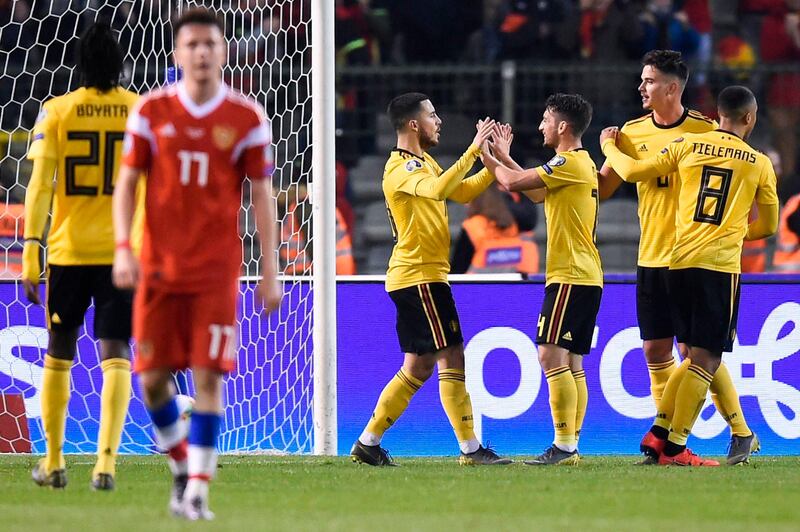 Hazard celebrates with Dries Mertens, third right, and teammates after scoring a goal. AFP