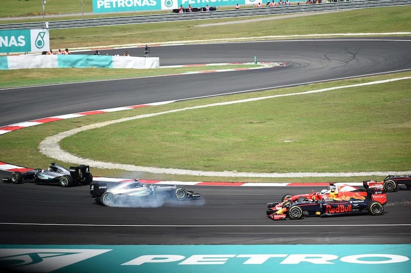 Mercedes-GP driver Nico Rosberg spins out of control after being clipped by Ferrari’s Sebastian Vettel. Mohd Rasfan / AFP