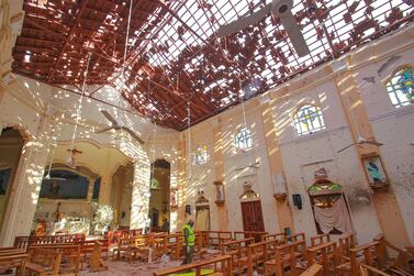 A crime scene official inspects the site of a bomb blast inside a church in Negombo, Sri Lanka April 21, 2019. REUTERS/Stringer NO RESALES. NO ARCHIVES.