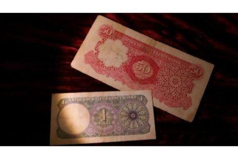 From left, Qatar riyals, a 100 rupee bank note of India issued in 1959 and different denominations of bank notes of Bahrain used in Abu Dhabi from 1966-1973 are some of the currencies from Mr Al Mutairi's collection.
