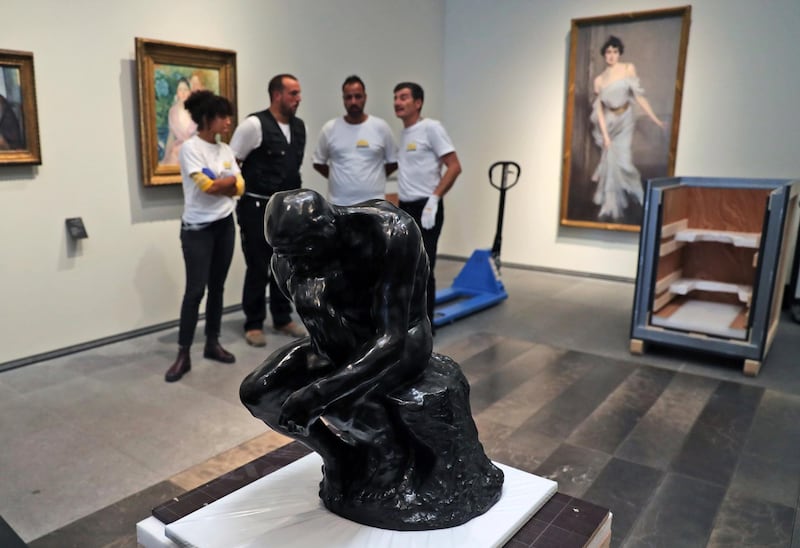 The staff removed the Rodin's 'Thinker' bronze statue from it's package to install it at the Louvre Museum in Abu Dhabi. Kamran Jebreili / AP photo