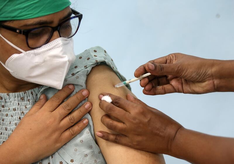 A beneficiary gets the first dose of a Covid-19 vaccine shot manufactured by Serum Institute of India at Rajawadi Hospital in Mumbai, India. EPA