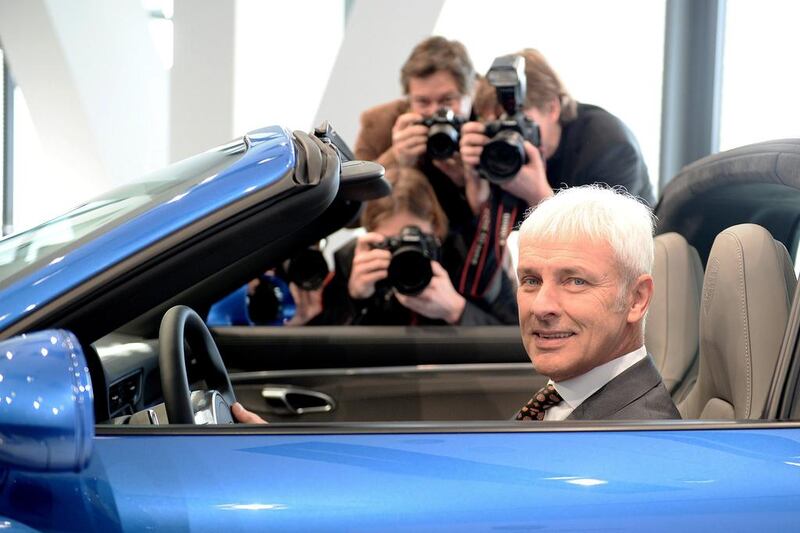 Matthias Mueller, head of German carmaker Porsche, poses inside a Porsche 911 Targa 4S luxury sports car on the sidelines of the company’s annual press conference at the Porsche museum in Stuttgart Zuffenhausen, southern Germany. Bernd Weissbrod / AFP /DPA
