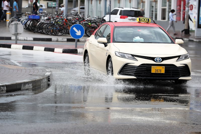 A taxi negotiates flooded roads in Al Karama, Dubai. Pawan Singh / The National
