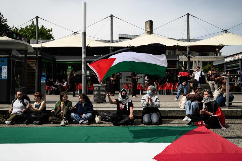 Students wave Palestinians flag during a rally near the entrance of an Institute of Political Studies building in Grenoble, France. AFP