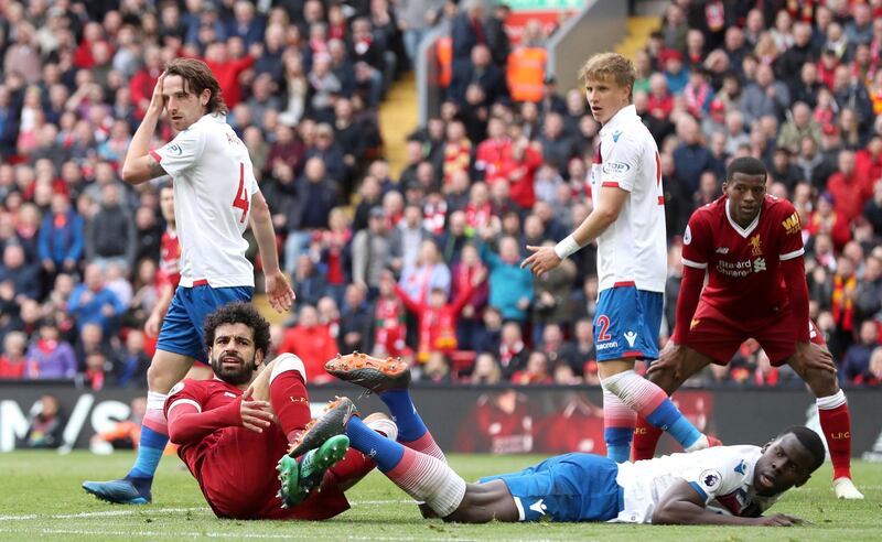 Liverpool's Mohamed Salah foreground left, reacts after a tackle, during the English Premier League soccer match between Liverpool and Stoke City, at Anfield, in Liverpool, England, Saturday April 28, 2018. (Martin Rickett/PA via AP)