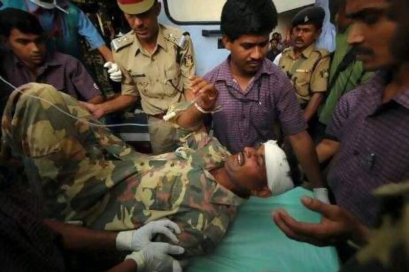 Paramedics rush an injured policeman to hospital in Nagpur on Tuesday. A roadside bomb triggered by suspected Maoist guerrillas killed 11 policemen and injured 29 in a remote part of the western Indian state of Maharashtra, police said.