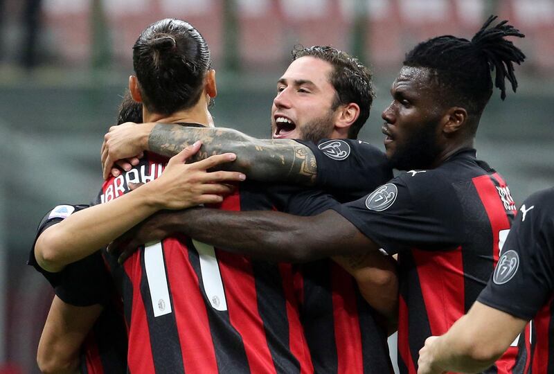 Zlatan Ibrahimovic celebrates with teammates after scoring AC Milan's second goal against Bologna. EPA