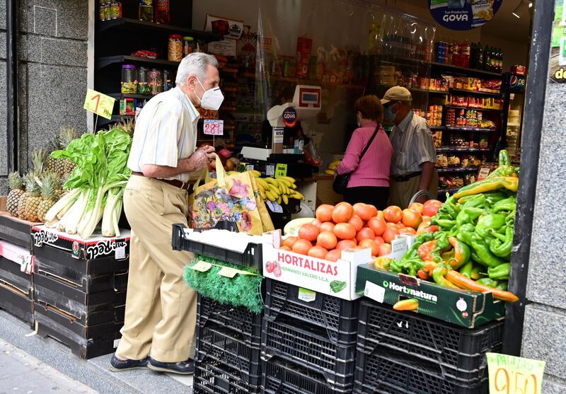 A man makes his purchases in the streets of Vallecas neighbourhood, in Madrid. EPA