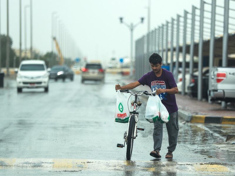 Abu Dhabi, U.A.E., February 2, 2019.   Sudden downpour at Khalifa City, Abu Dhabi.  A man walks his bike in the rain during a sudden downpour.
Victor Besa/The National
Section:  NA
Reporter: