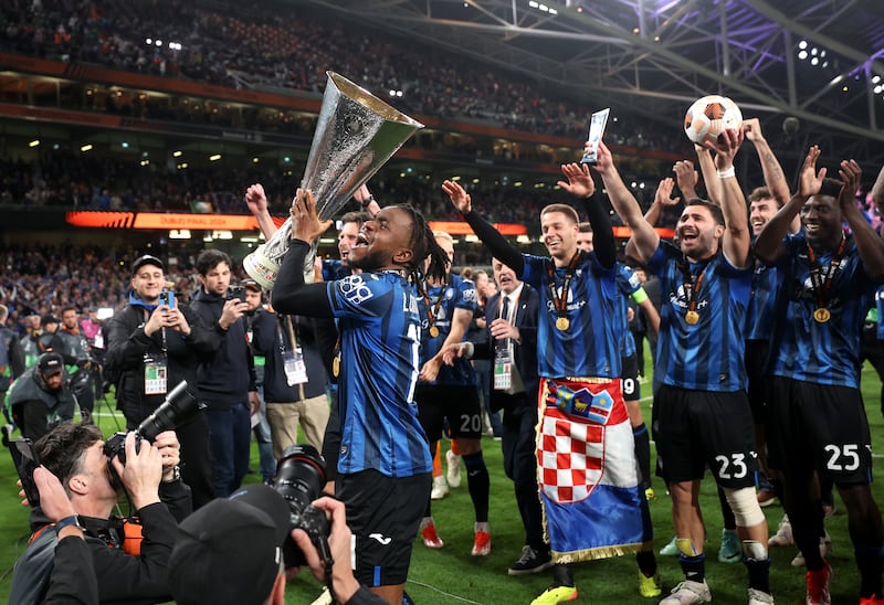Ademola Lookman celebrates with the Europa League trophy after his hat-trick led Atalanta to victory over Bayer Leverkusen. Getty Images