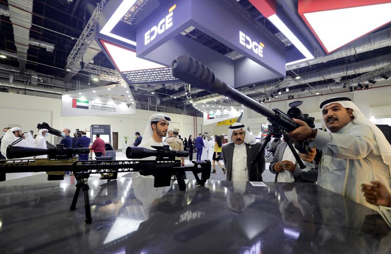 Visitors check weapons at the UAE stand. Reuters