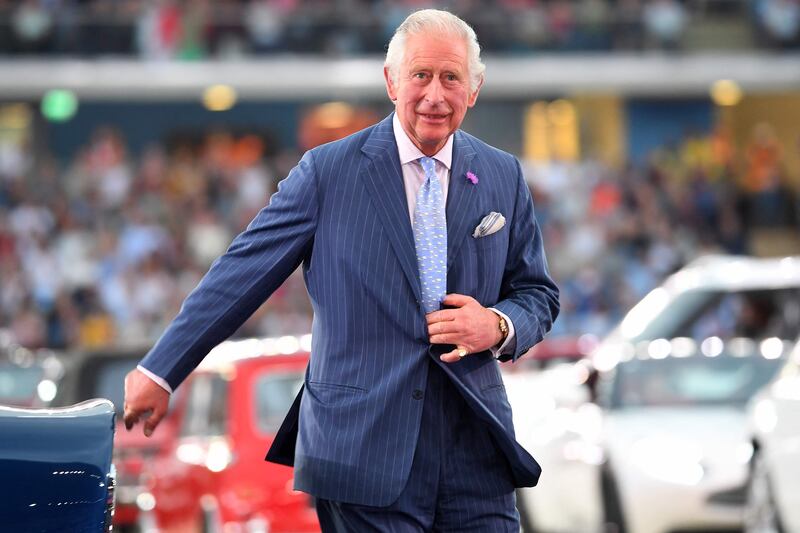 Prince Charles steps out of an Aston Martin sportscar after driving himself and the Duchess of Cornwall into Alexander Stadium in Birmingham. AFP