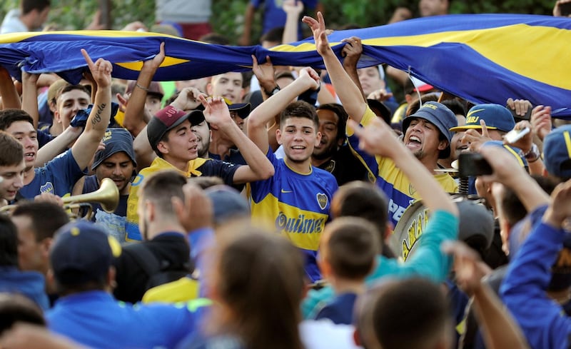 Boca Juniors' fans cheer as their team heads on to Spain. Reuters