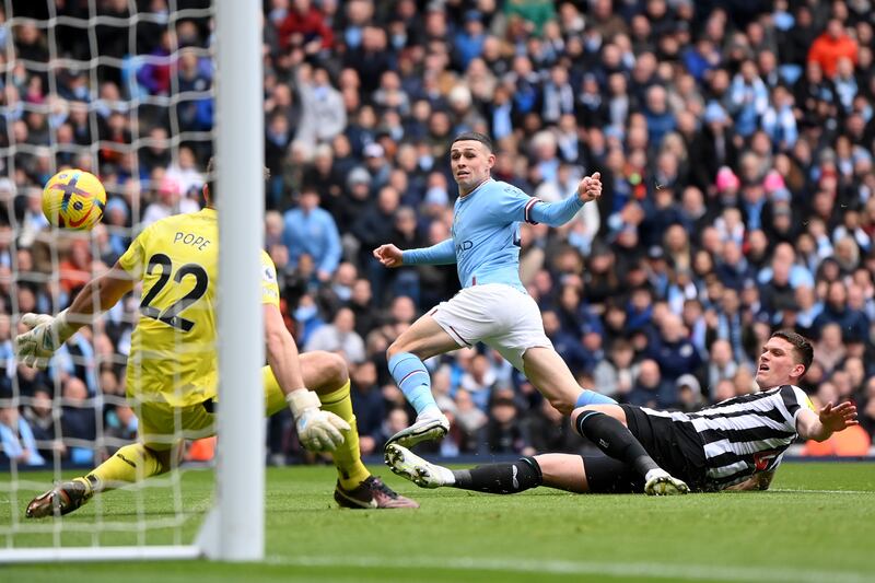 Phil Foden scores Manchester City's early opener via a deflection off Newcastle defender Sven Botman. Getty