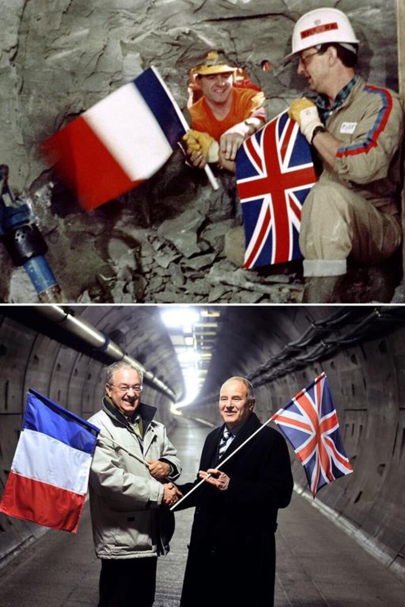 In top photo, Channel Tunnel workers Philippe Cozette from France, right, and Graham Fagg from England shake hands while holding their respective national flag during the ceremonial breakthrough on December 1, 1990. The two met again on February 10, 2014 in the maintenance tunnel, bottom tunnel. AFP